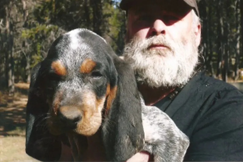 Steve Phipps holding a Bluetick pup